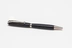 A black Irish Bog Oak wooden pen with antique rose copper fittings, displayed against a white background.